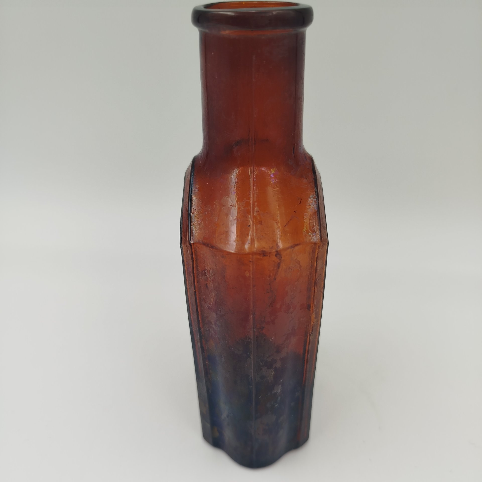 Флакон коричневого цвета с уплощенным туловом