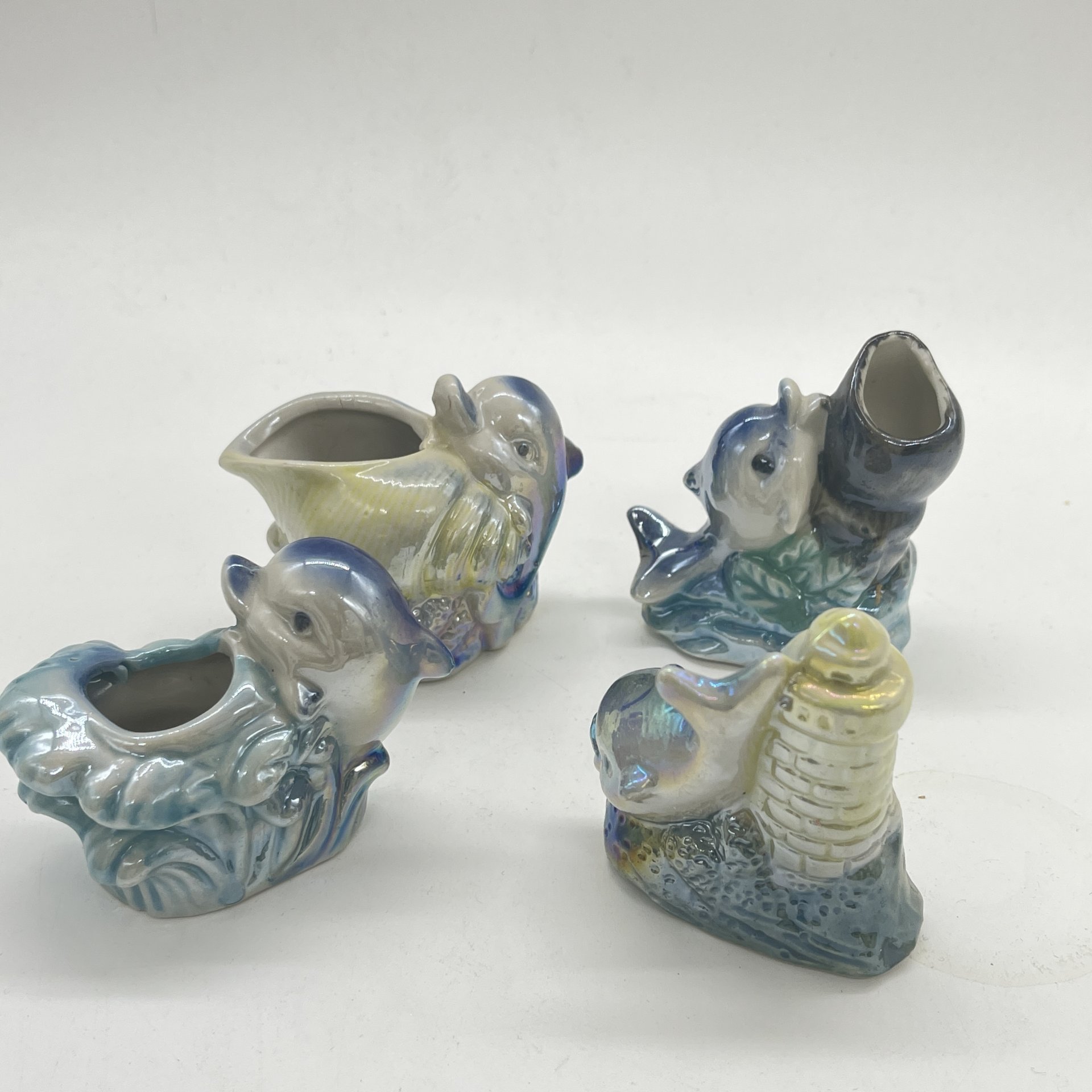 Набор из 4 статуэток "Дельфинчики" с морскими атрибутами, керамика, люстр, аэрограф, Россия, 1990-2010 гг.