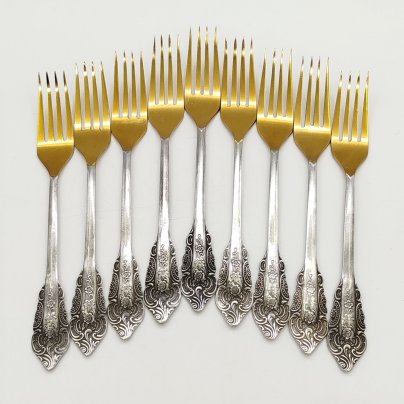 Набор из 9-ти столовых вилок, украшенных растительным декором, нержавеющая сталь, золочение, Павловский завод художественных металлоизделий им. С.М. Кирова, СССР