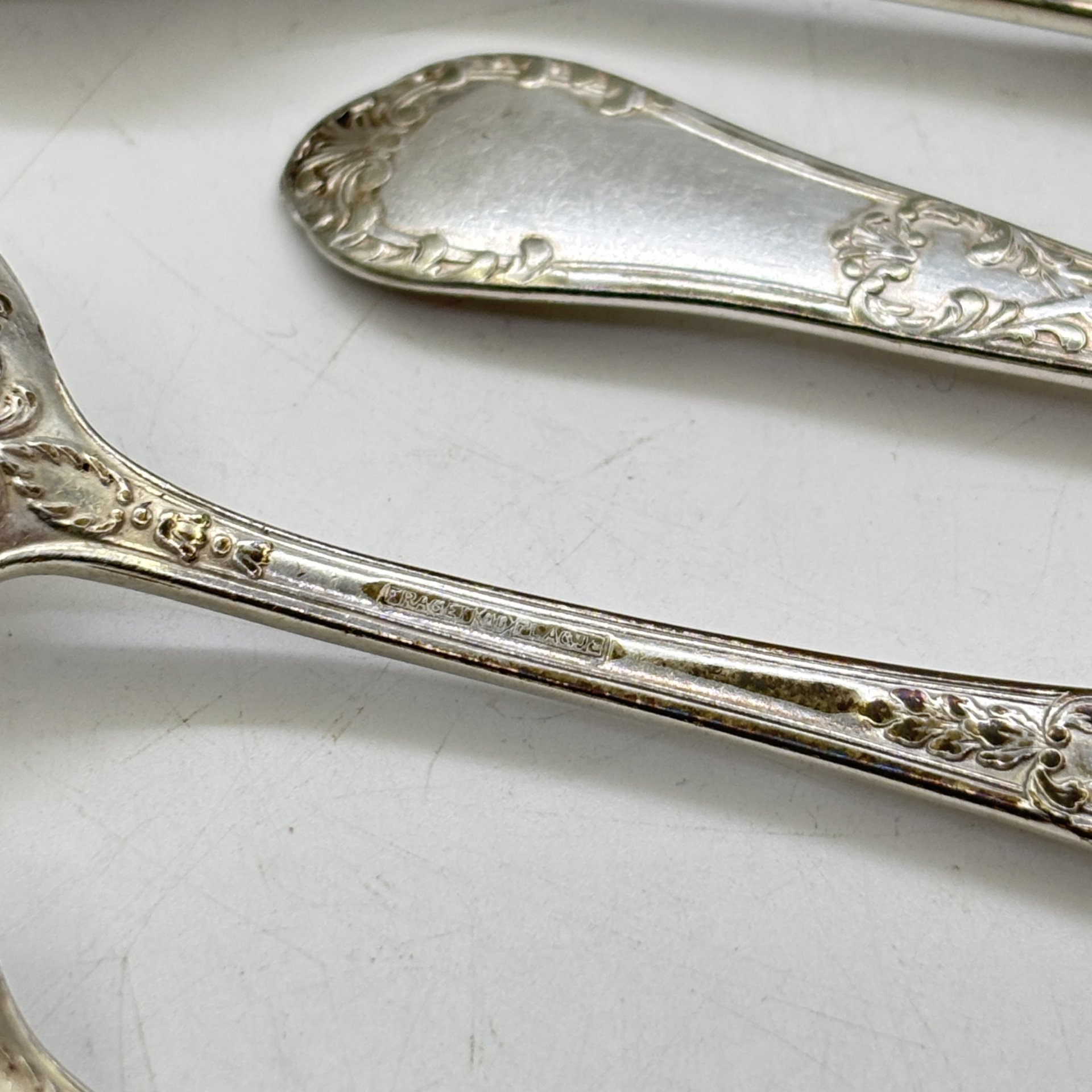 Набор из девяти чайных ложек с растительным декором, металл, серебрение, Fraget (Фабрика серебряных и плакированных изделий Иосифа Фраже), Царство Польское, 1890-1917 гг.