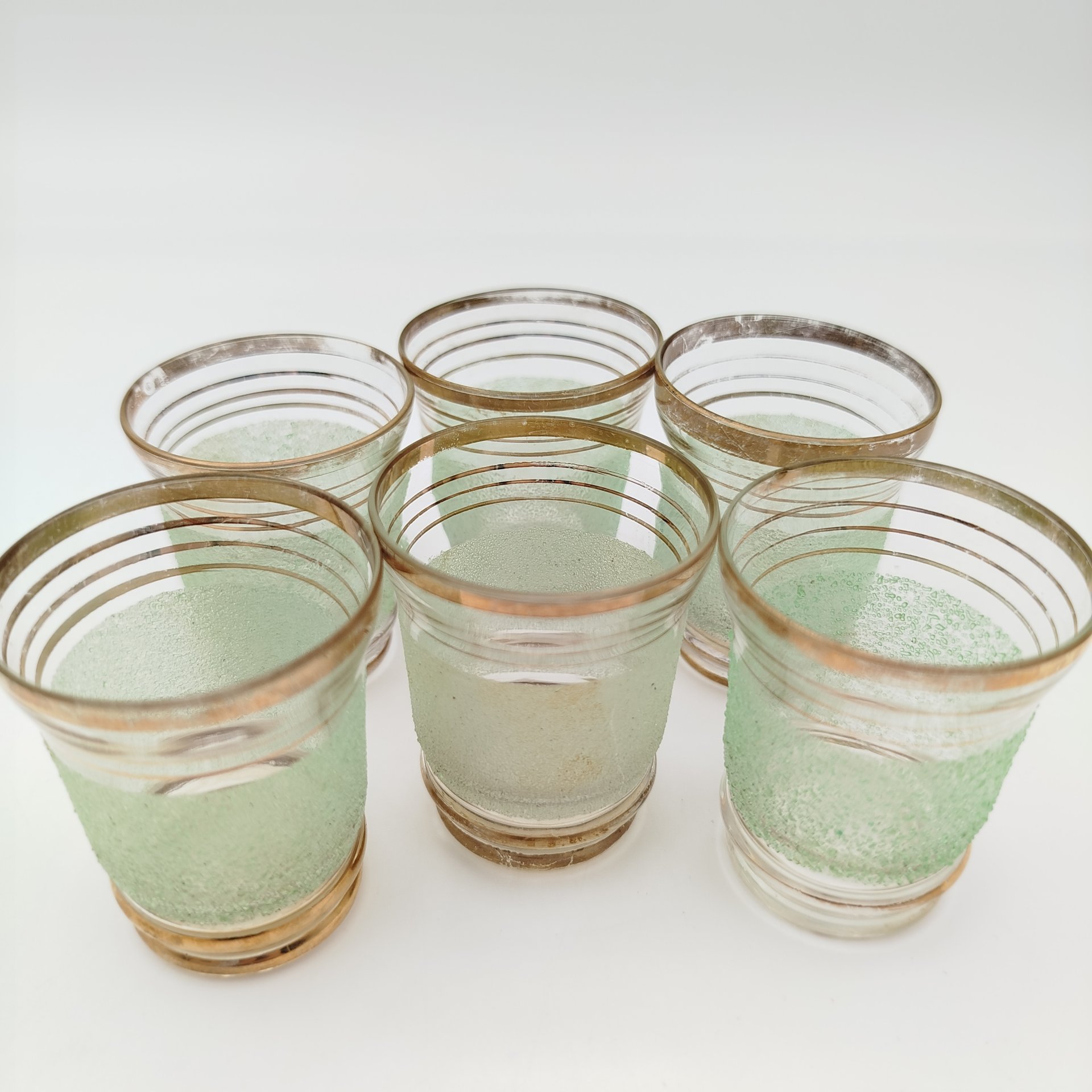 Набор для подачи крепких напитков на 6 персон (штоф и рюмки), декорированный обсыпкой из стеклянной крошки зелёного цвета, автор Н.А. Воинов, стекло, золочение, Завод «Красный Гигант», СССР, 1960-1980 гг.