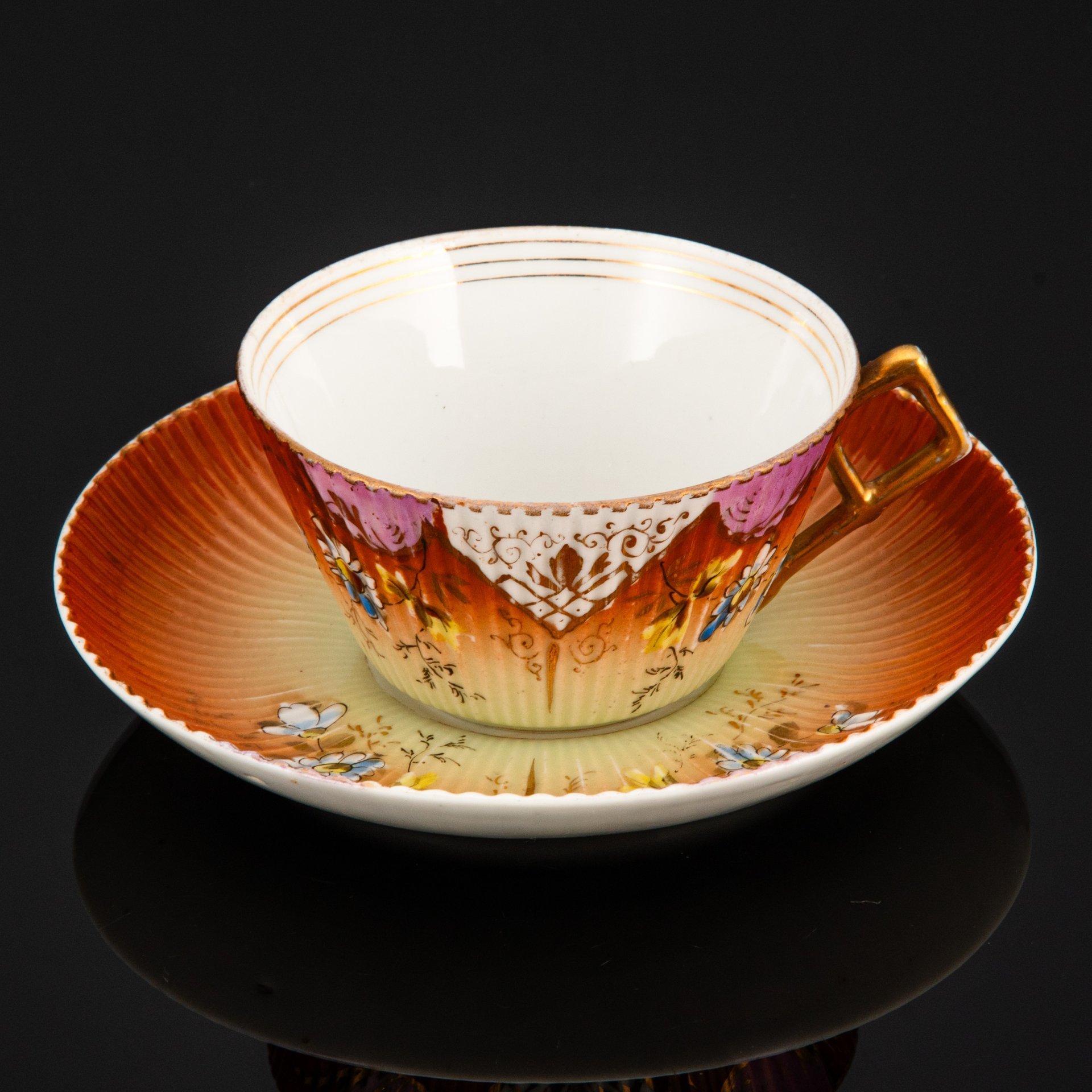 Пара чайная формы "французской рамкой ручка" с декором в виде ромашек на градиентном жёлто-охристом фоне, фарфор, роспись, крытье, золочение, Фабрика И.Е. Кузнецова на Волхове, Российская империя, 1900-1917 гг.