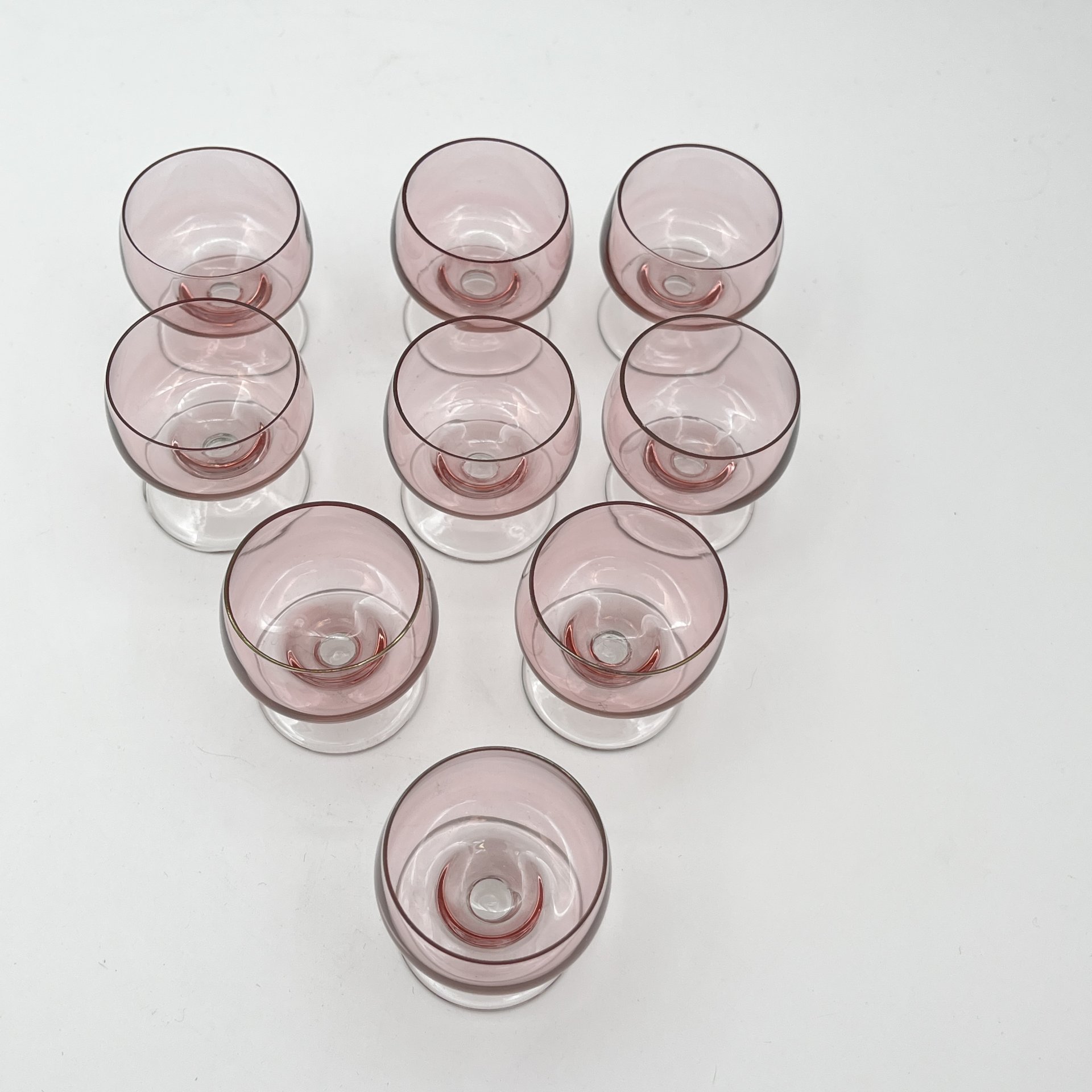 Набор из девяти рюмок нежно-розового оттенка, стекло, СССР, 1960-1990 гг.