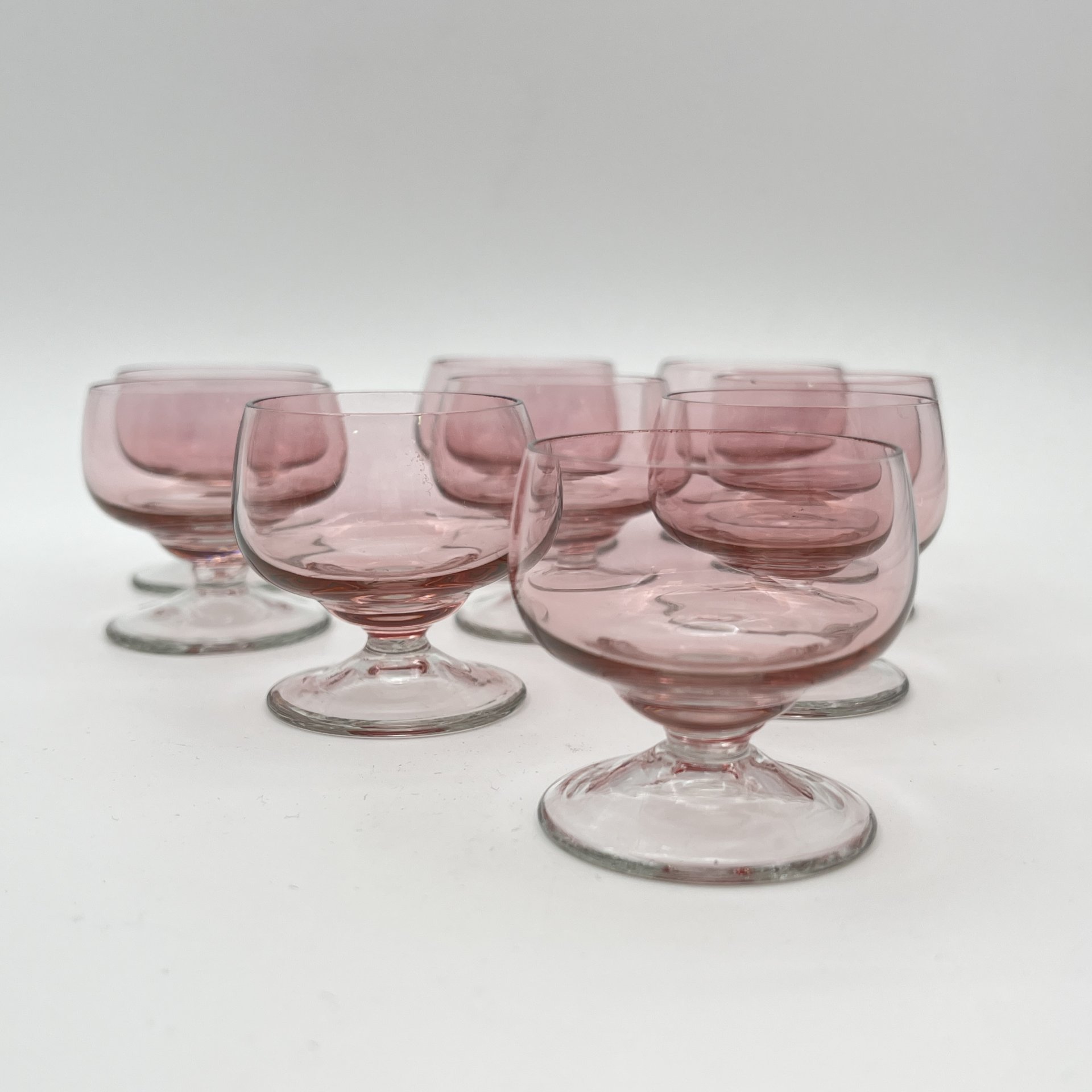 Набор из девяти рюмок нежно-розового оттенка, стекло, СССР, 1960-1990 гг.