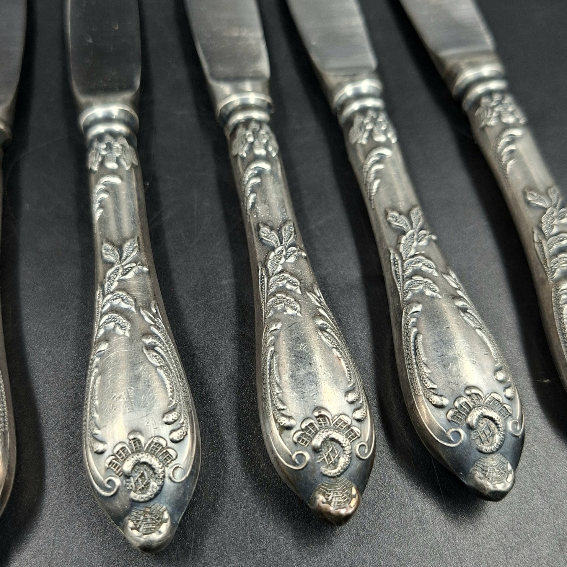 Набор из шести десертных ножей с растительным декором, мНЦ (медь-никель-цинк), сталь, Вольнянский завод столовых приборов им. Шевченко (ЗiШ, ЗиШ), СССР, 1960-1980 гг.