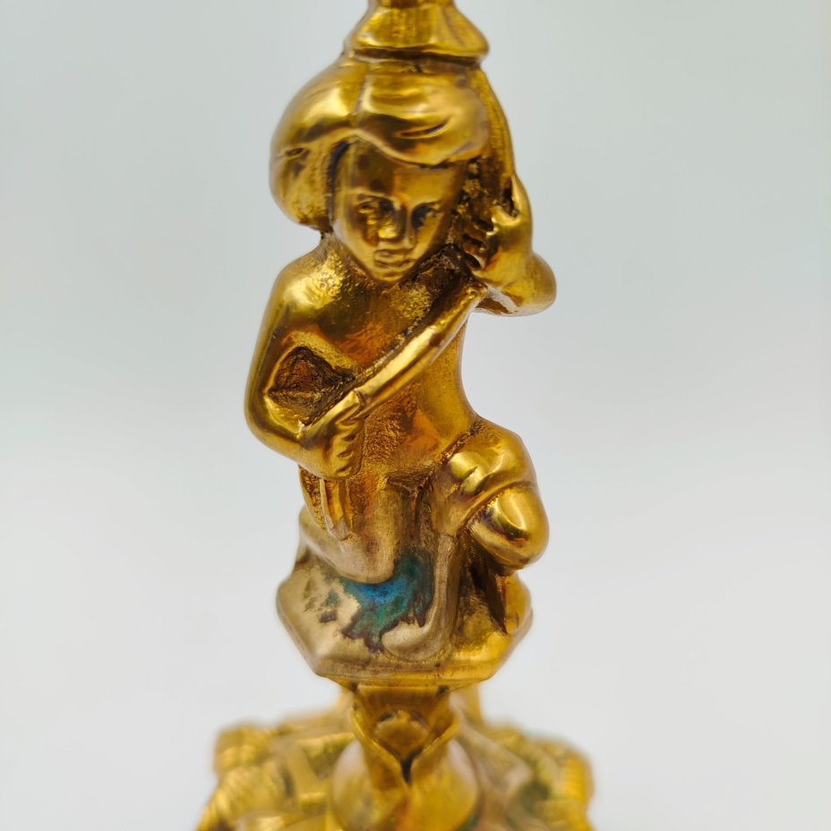 Подсвечник на фигурном основании в виде юноши с растительным побегом