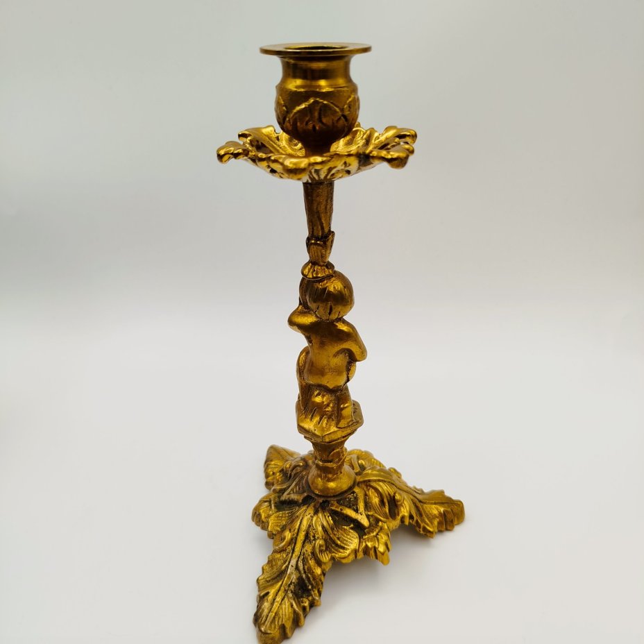 Подсвечник на фигурном основании в виде юноши с растительным побегом