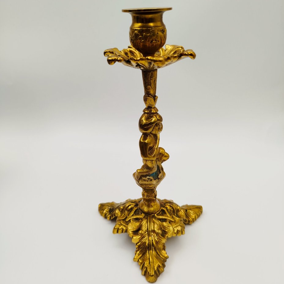 Подсвечник на фигурном основании в виде юноши с растительным побегом