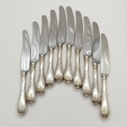 Набор из десяти десертных ножей с растительным декором, мНЦ (медь-никель-цинк), сталь, Вольнянский завод столовых приборов им. Шевченко (ЗiШ, ЗиШ), СССР, 1960-1990 гг.