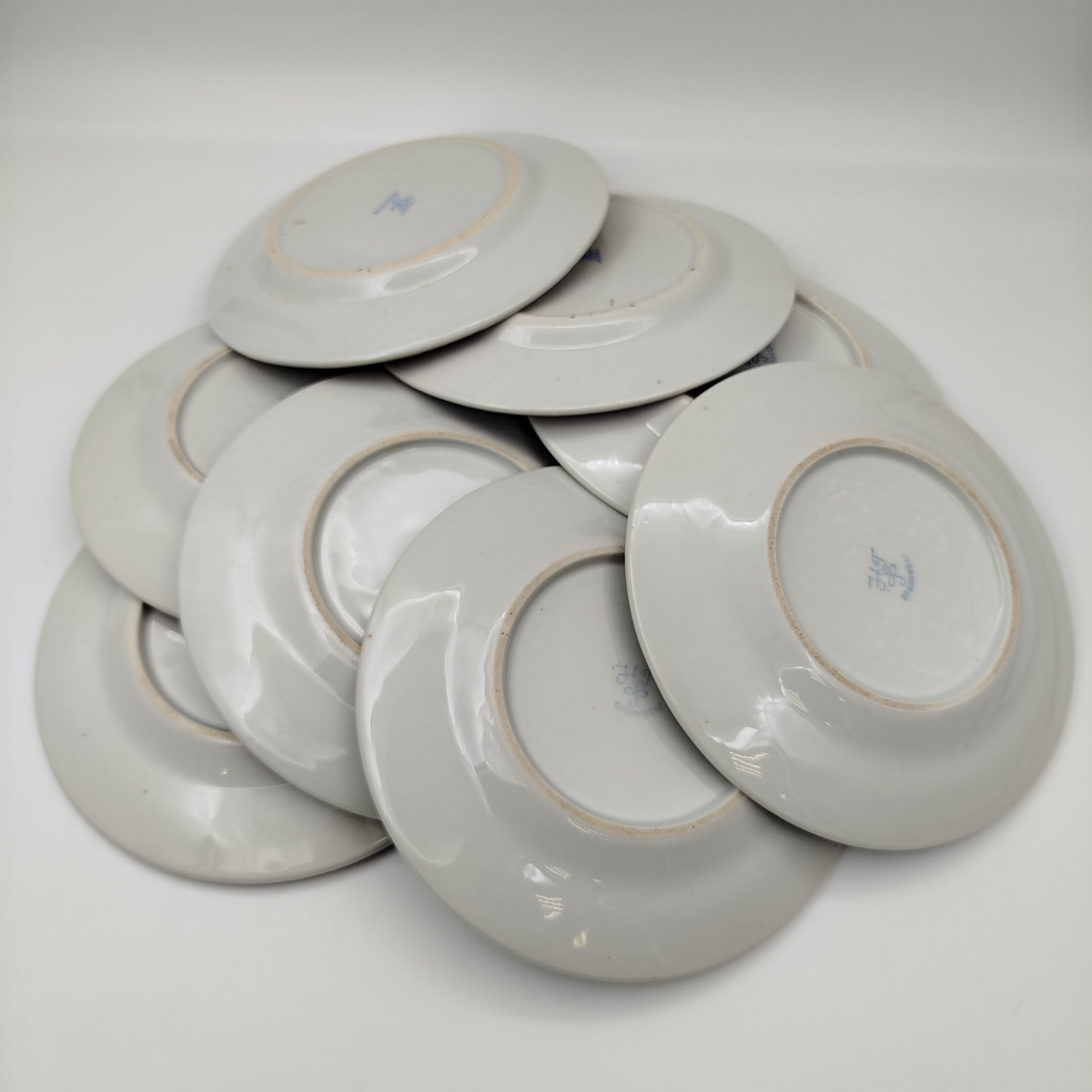 Набор из восьми десертных (закусочных) тарелок с орнаментальной каймой, клеймо «Новгубфарфор», фарфор, обводка, золочение, Завод «Красный фарфорист» (Чудово, Грузинская фарфорово-фаянсовая фабрика), СССР, 1923-1927 гг.